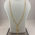 A gold necklace displayed on a white mannequin bust, with a digital scale visible underneath. The necklace features a delicate chain with small bead-like details and a textured pendant.