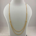 A double-strand gold chain necklace displayed on a white jewelry bust, with a digital scale visible underneath.
