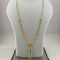 A gold necklace displayed on a white mannequin bust, with a digital scale underneath to show weight. The necklace features a delicate chain with small bead details and a central pendant with a blue-green stone.