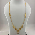 A gold necklace displayed on a white mannequin bust, with a digital scale visible underneath. The necklace features a delicate chain with five ornate gold floral clusters arranged in a V-shape at the center, culminating in a small star pendant.