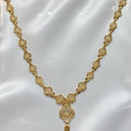 Gold necklace on a white card with a visible price tag.