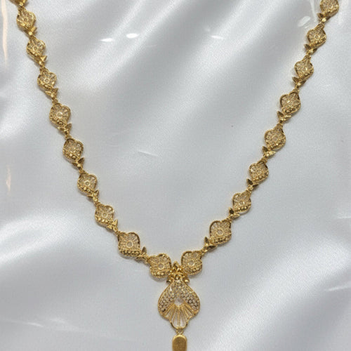 Gold necklace on a white card with a visible price tag.