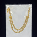 Gold heart-shaped necklace on a clear plastic bag with a black background