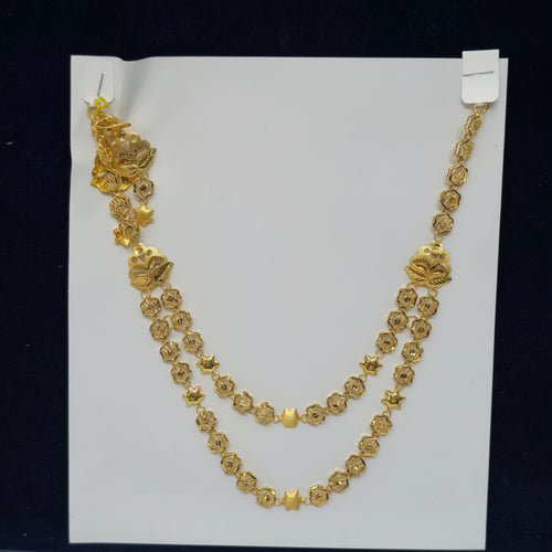 Gold necklace on a white card with a label