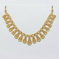 Gold necklace on a clear plastic bag with a price tag.