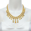 Gold necklace on a clear plastic card with a dark background